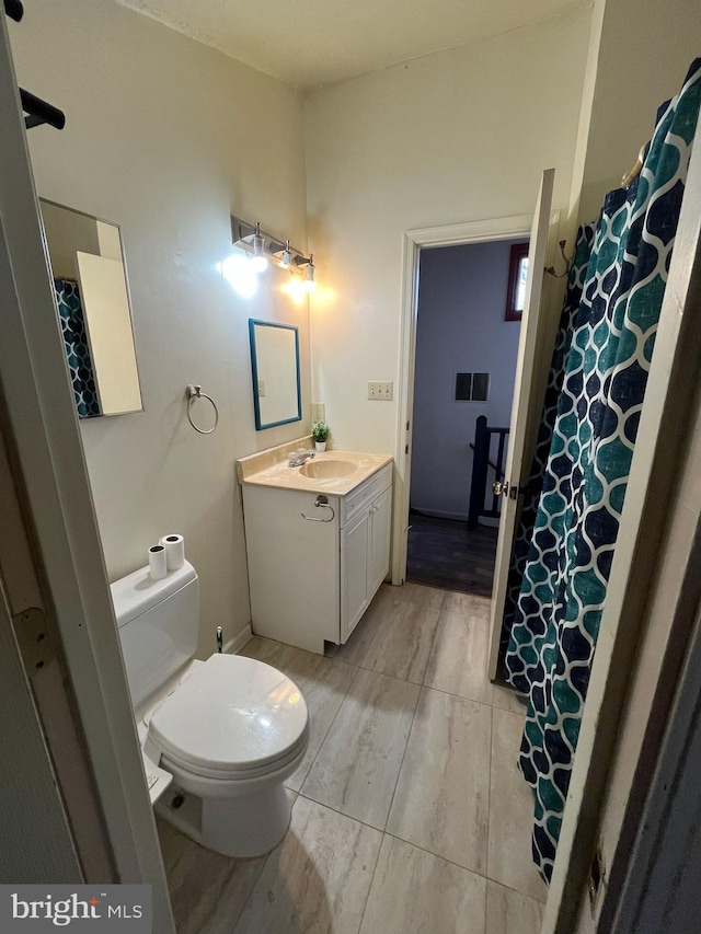 bathroom with toilet and vanity