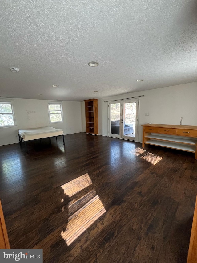 interior space with access to exterior, dark wood finished floors, and french doors