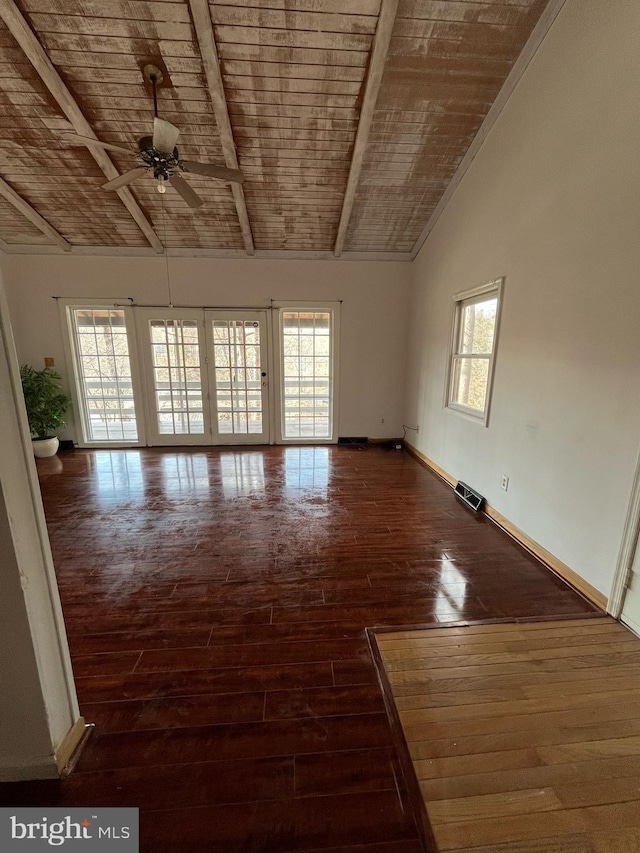 empty room featuring wooden ceiling, baseboards, visible vents, and hardwood / wood-style floors