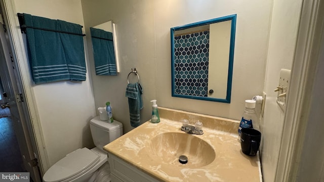 bathroom with toilet and vanity