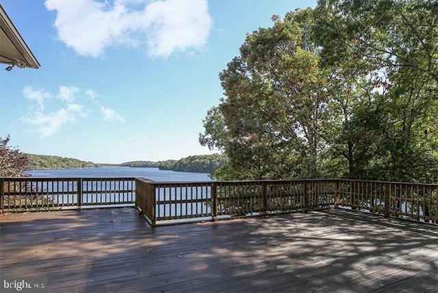 wooden deck with a water view