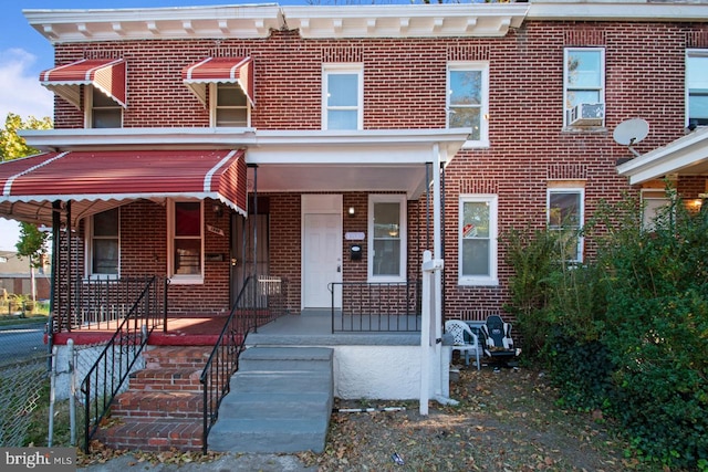 view of front facade with covered porch and brick siding