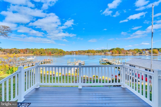 deck with a dock and a water view