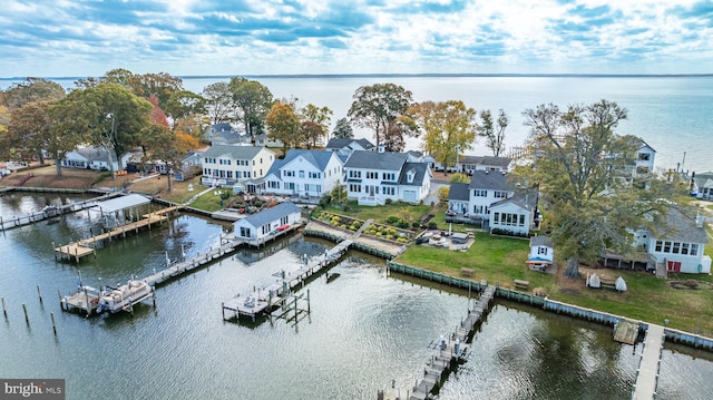 birds eye view of property featuring a water view and a residential view