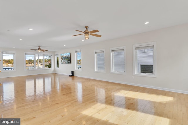 unfurnished living room featuring light wood-type flooring, baseboards, a ceiling fan, and recessed lighting