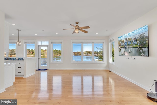 interior space with light wood-type flooring, baseboards, and recessed lighting