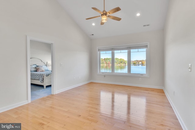 unfurnished bedroom featuring high vaulted ceiling, recessed lighting, visible vents, baseboards, and light wood-style floors