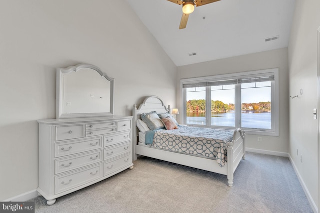 bedroom featuring baseboards, visible vents, and light colored carpet