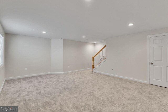 below grade area featuring baseboards, stairway, carpet flooring, and recessed lighting