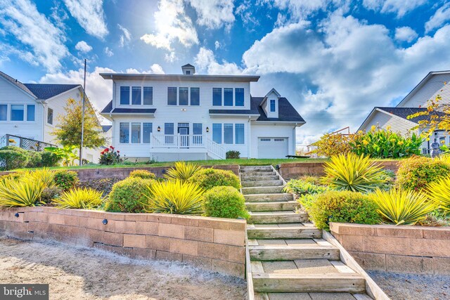 view of front of house with a garage and stairs