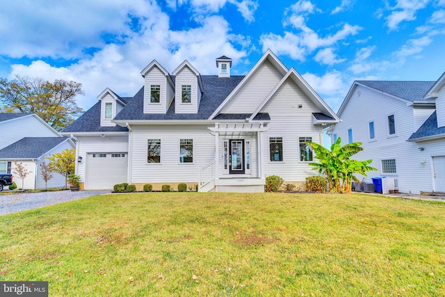 view of front of property with a shingled roof, an attached garage, driveway, and a front lawn