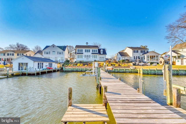 dock area featuring a water view and a residential view