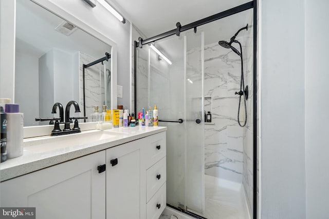 full bath with visible vents, vanity, and a marble finish shower