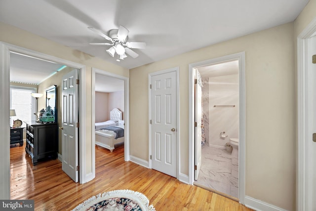 hall featuring wood finished floors and baseboards