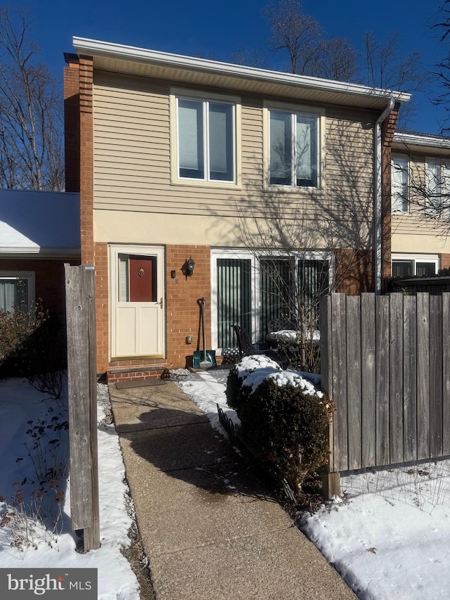 view of front of property with fence and brick siding