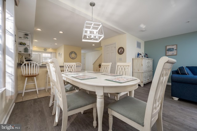 dining area featuring recessed lighting, wood finished floors, visible vents, baseboards, and an inviting chandelier