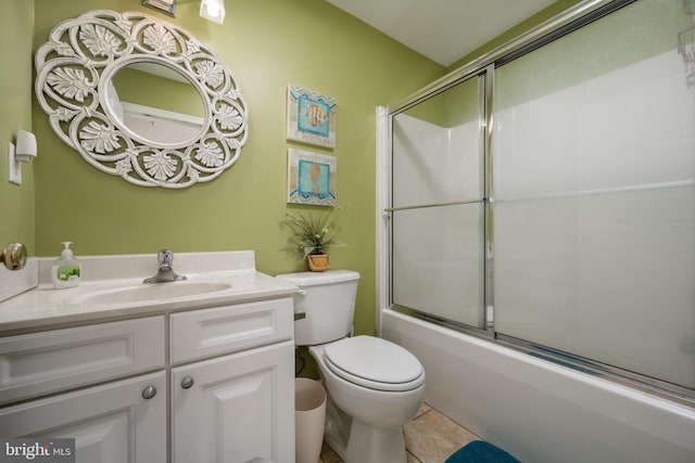 bathroom with toilet, shower / bath combination with glass door, tile patterned flooring, and vanity