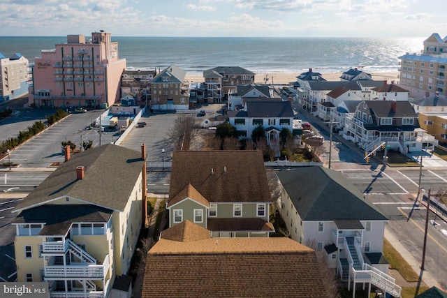 drone / aerial view featuring a residential view and a water view