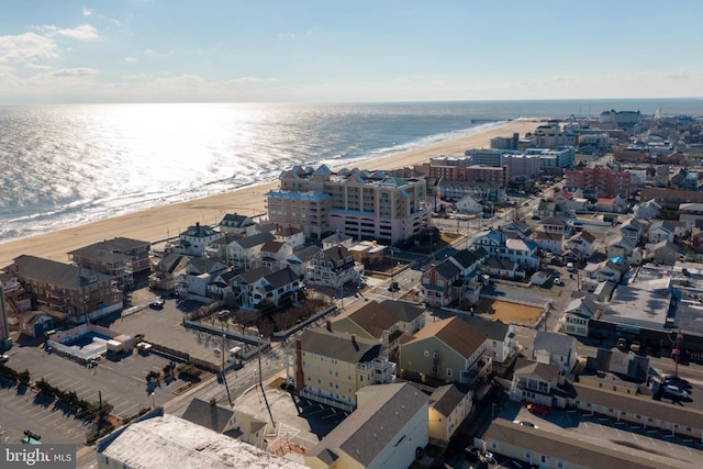 bird's eye view with a water view and a beach view