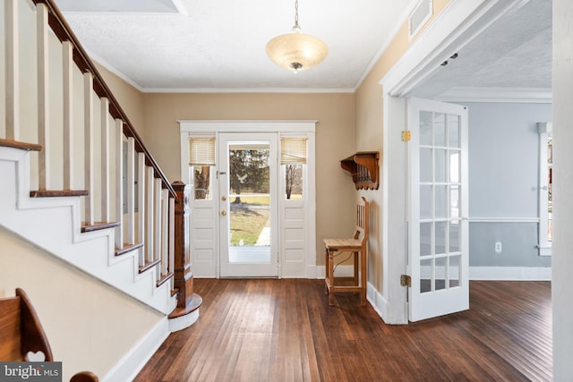 entryway featuring visible vents, dark wood-type flooring, baseboards, stairs, and ornamental molding