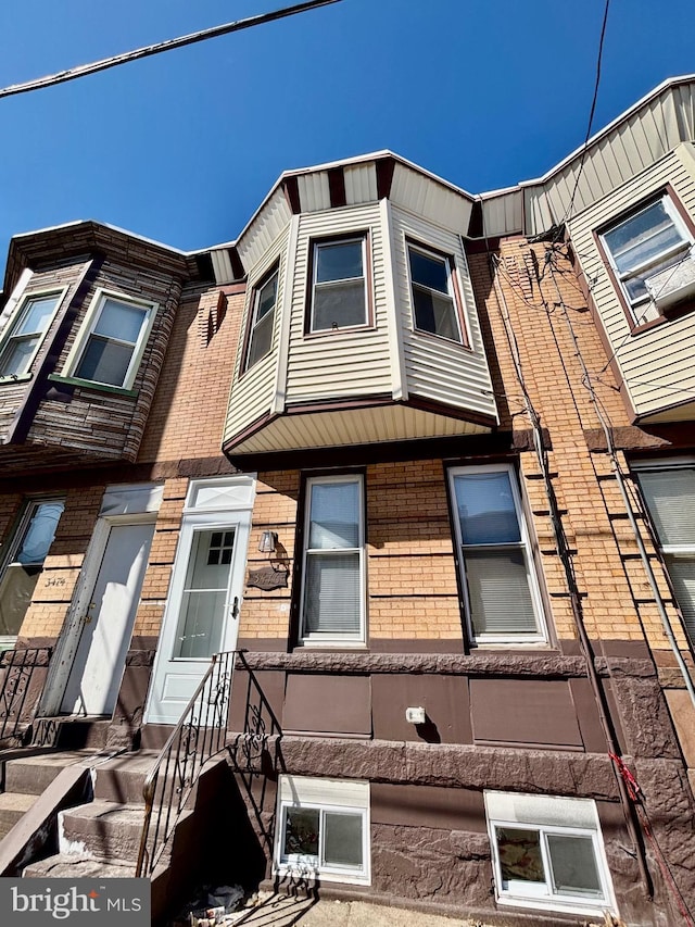 townhome / multi-family property featuring brick siding