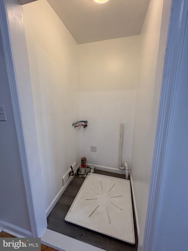 laundry area with baseboards