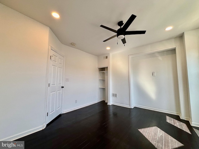 unfurnished bedroom featuring dark wood-type flooring, recessed lighting, visible vents, and baseboards