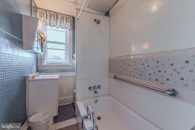 full bath featuring a bathtub, walk in shower, tile walls, and vanity