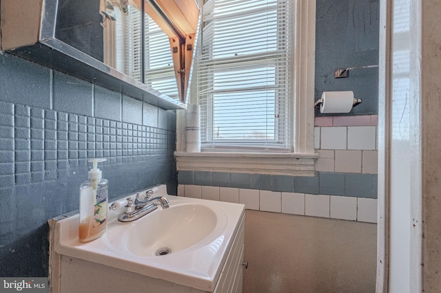 bathroom featuring tile walls and vanity