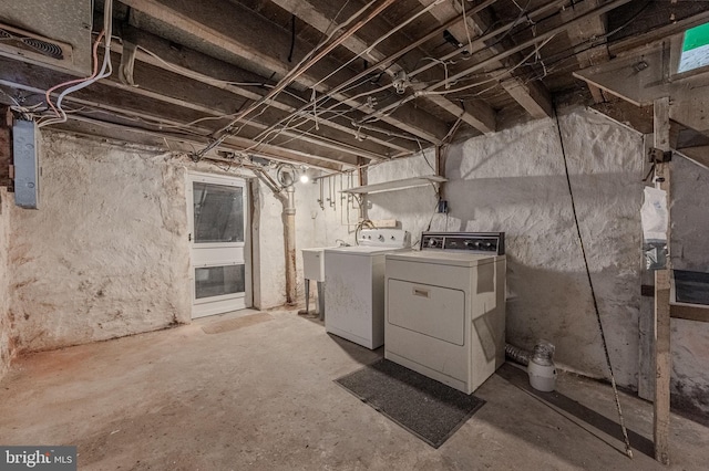 unfinished basement featuring washing machine and dryer and a sink