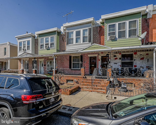 multi unit property with covered porch and brick siding