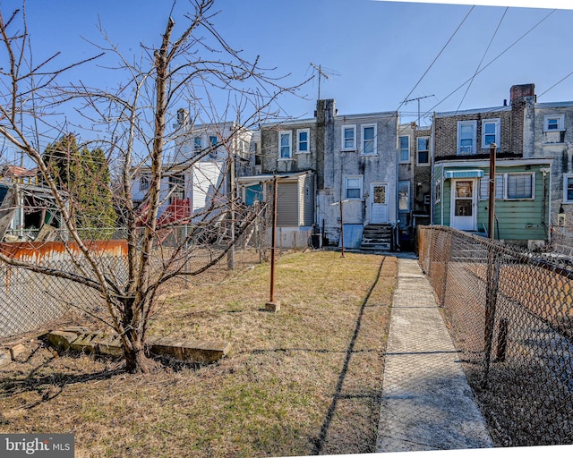 view of yard featuring a fenced front yard and a residential view