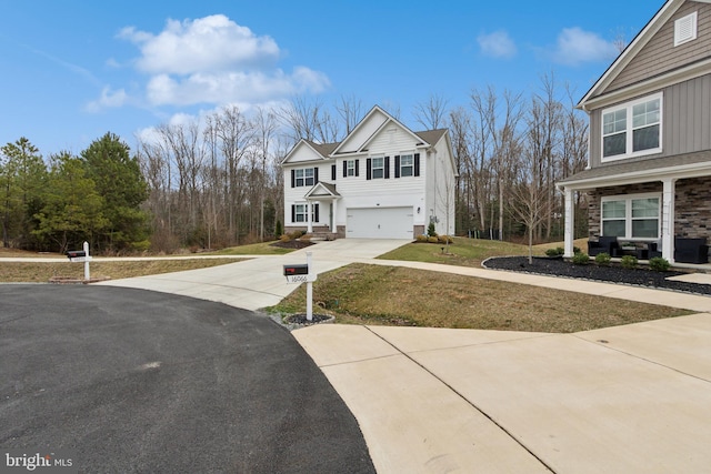 view of front of property featuring an attached garage, a front lawn, and concrete driveway