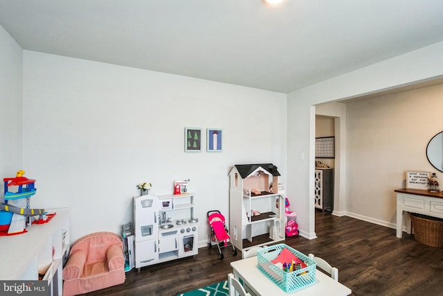 playroom featuring baseboards and wood finished floors