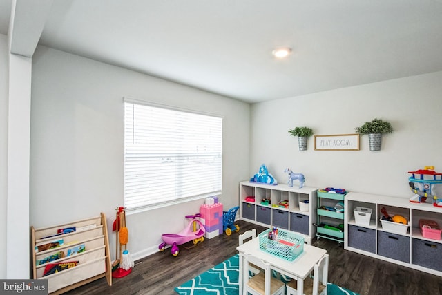 game room with baseboards and wood finished floors