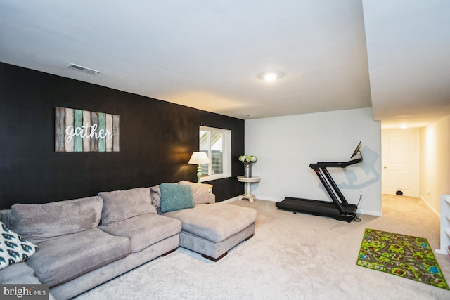 living area featuring baseboards, visible vents, and carpet flooring