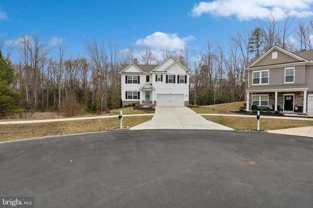 view of front of home with stone siding, concrete driveway, a front lawn, and an attached garage