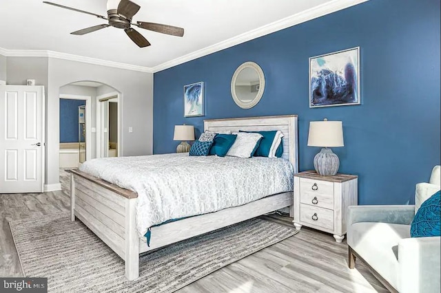 bedroom featuring arched walkways, ceiling fan, ornamental molding, and wood finished floors