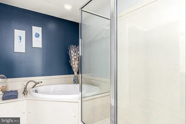 full bath featuring a stall shower and a bath