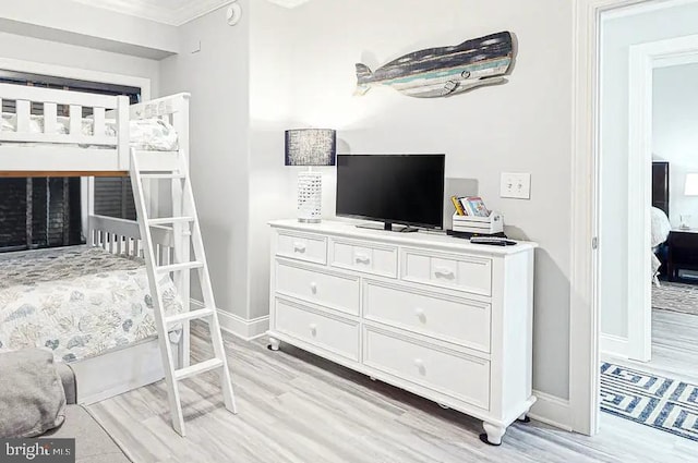 bedroom featuring light wood-style flooring and baseboards