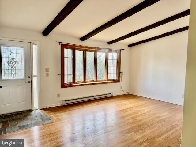 entrance foyer featuring a baseboard heating unit, beam ceiling, baseboards, and wood finished floors