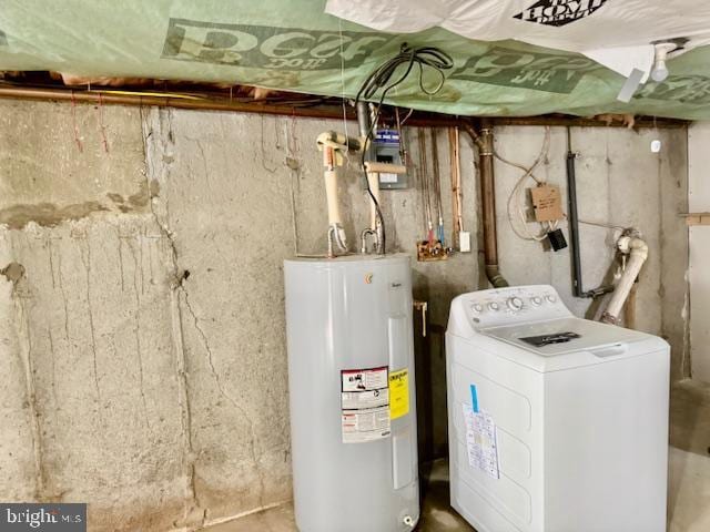 utility room with water heater and washer / dryer