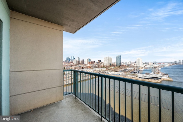 balcony featuring a water view and a city view