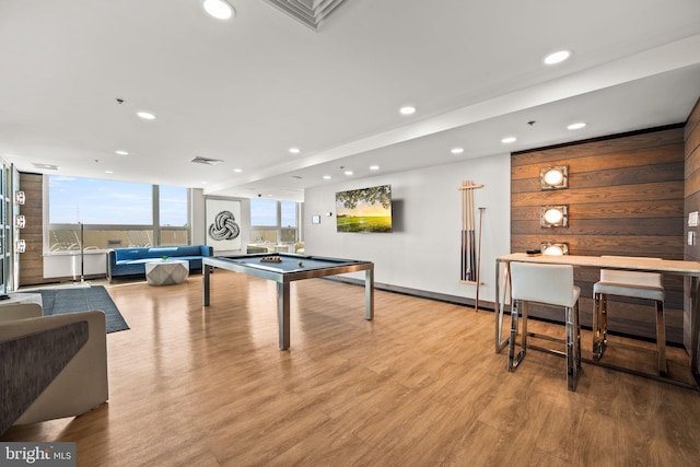 playroom featuring recessed lighting, visible vents, expansive windows, wood walls, and wood finished floors