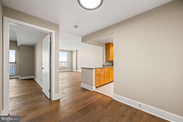 kitchen featuring baseboards and hardwood / wood-style flooring