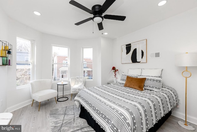 bedroom featuring recessed lighting, wood finished floors, visible vents, and baseboards