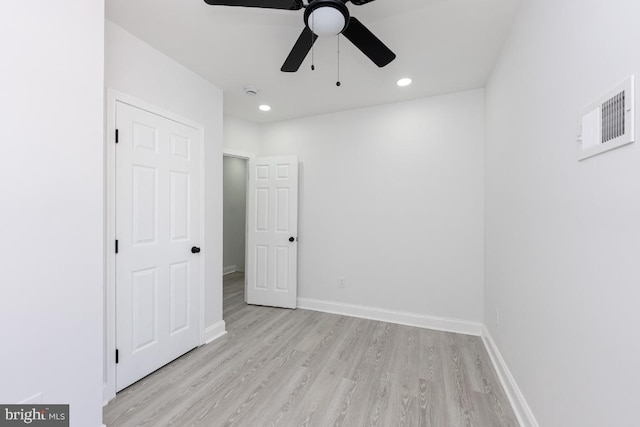 spare room featuring light wood finished floors, baseboards, visible vents, and recessed lighting