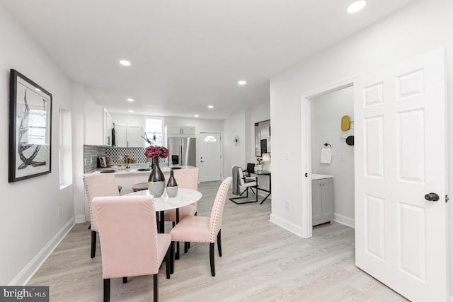 dining area with recessed lighting, baseboards, and light wood finished floors