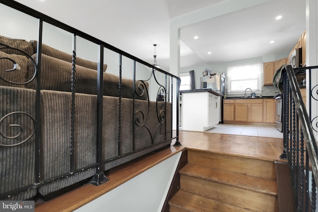 stairway featuring tile patterned flooring and recessed lighting