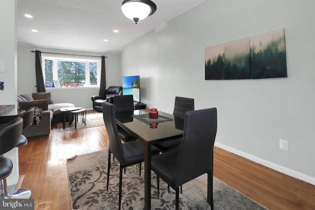 dining space featuring hardwood / wood-style floors, recessed lighting, and baseboards